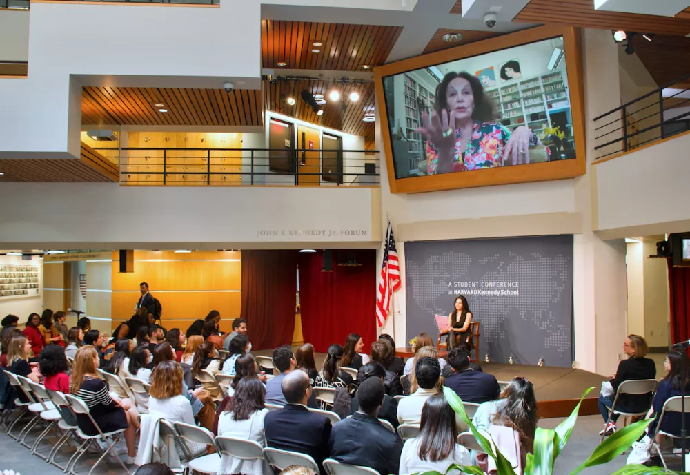 Keynote speaker Diane von Furstenberg on the big screen in the Forum with the audience in the foreground.