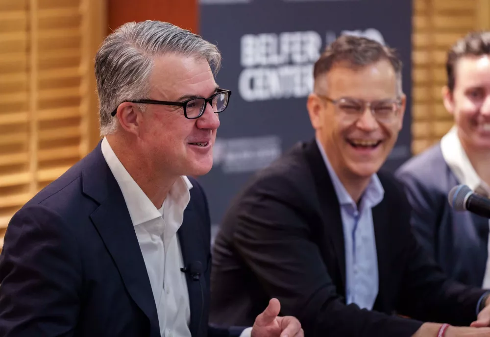 Eric Rosenbach, Dr. Colin Kahl, and Bethany Russell laughing smiling while sitting at the panel table.