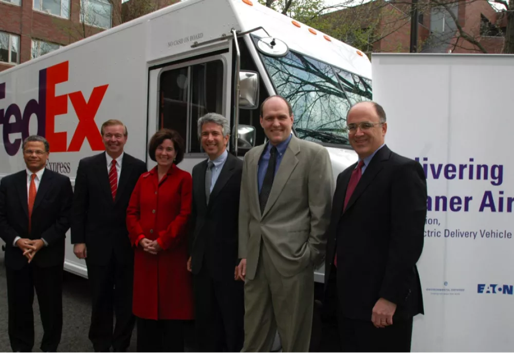 Members of the FedEx-Environmental Defense Fund Future Vehicle Project pose in front of a hybrid FedEx truck.