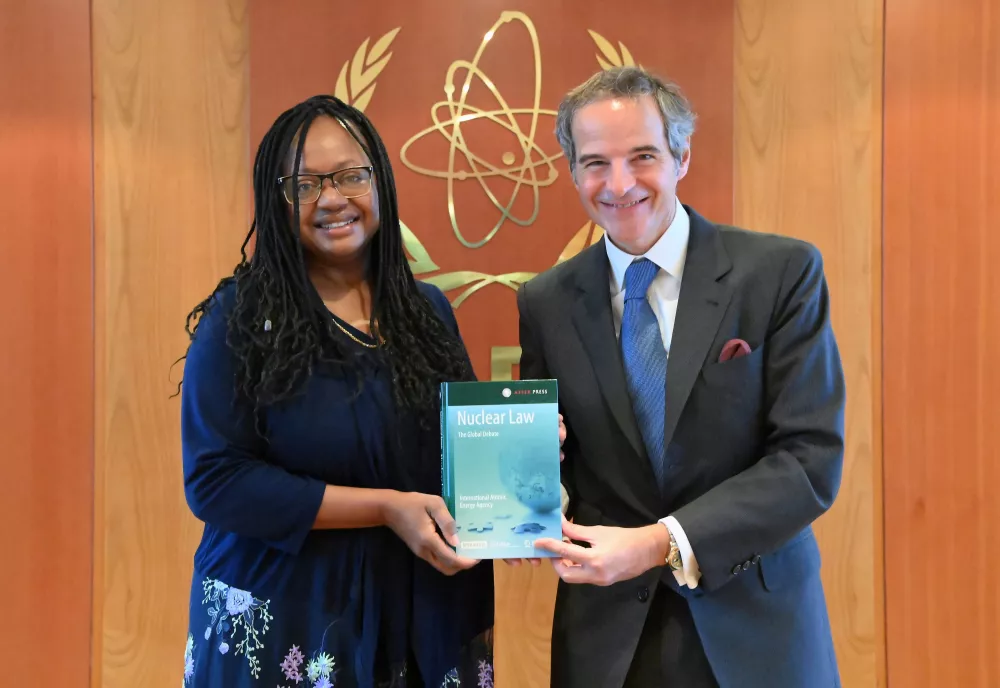 Bonnie Jenkins and Rafael Mariano Grossi posing with a book called "nuclear law."