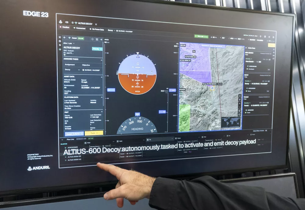 A hand points at a screen showing autonomous drone controls and flight data.