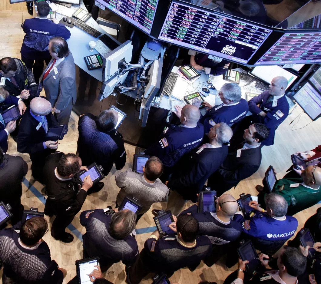 A group of workers gathered around monitors