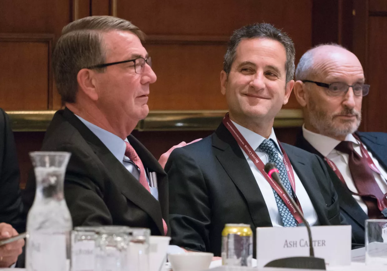 Ash Carter patting Laurence Belfer on the back as Laurence smiles.