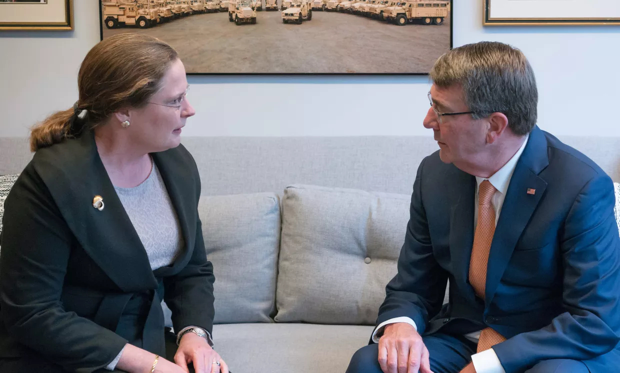 Amb. Laura Holgate and Ash Carter sitting on an office couch.