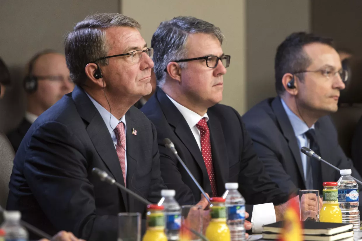 Ash Carter and Eric Rosenbach seated next to each other at a meeting table.