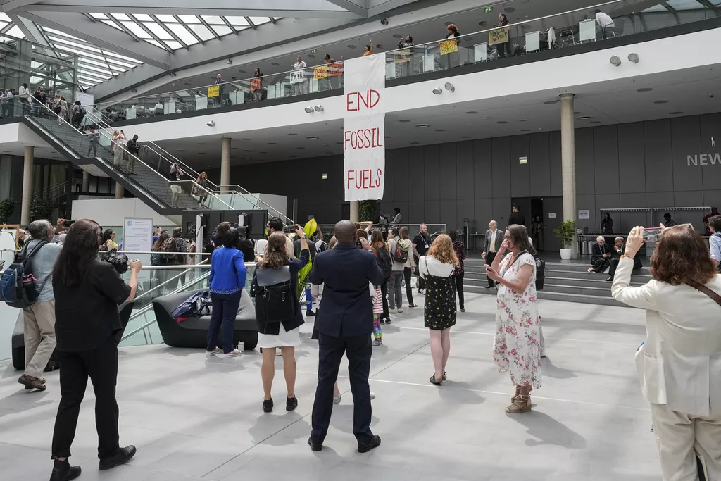 Climate activists display a banner calling for the end of fossil fuel use at the Bonn Climate Change Conference.