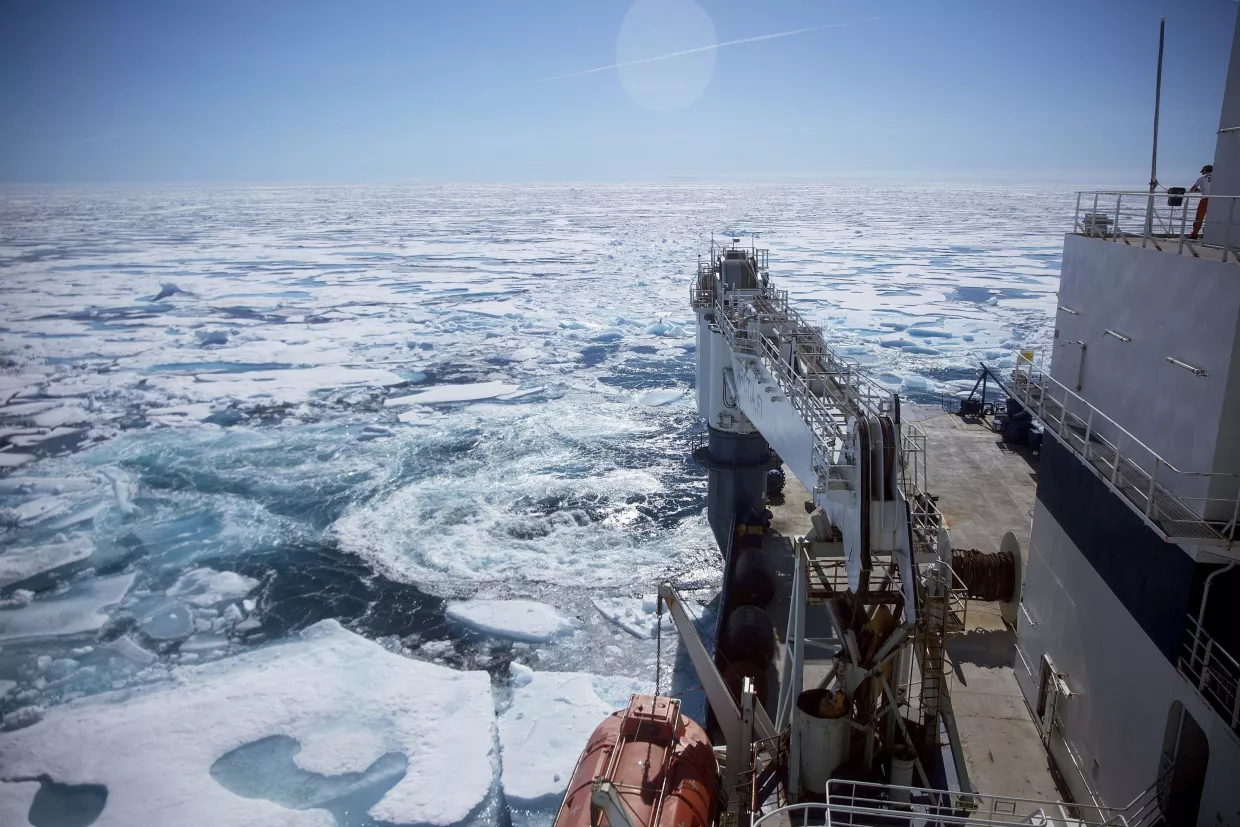 The Finnish icebreaker MSV Nordica, pushes through floating sea ice on the Victoria Strait while traversing the Northwest Passage in the Canadian Arctic Archipelago.