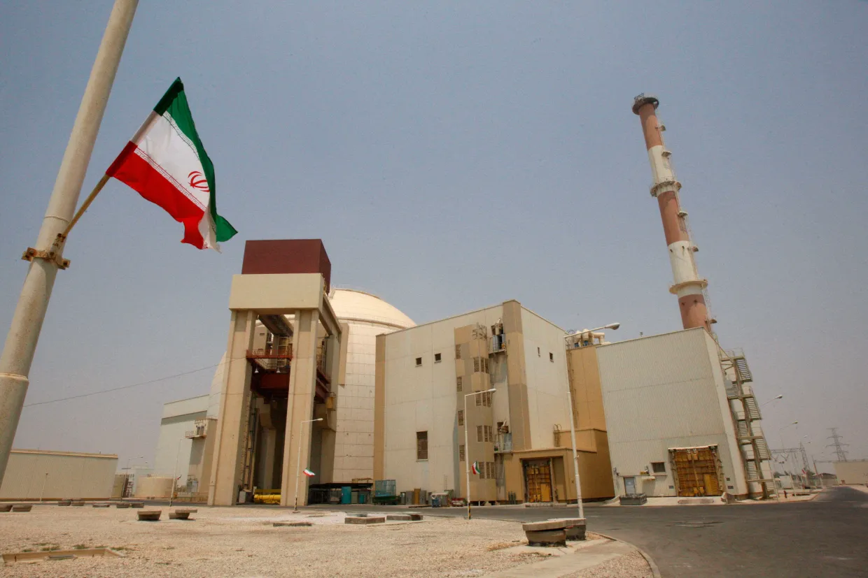 An Iranian flag flutters in front of the reactor building of the Bushehr nuclear power plant, just outside the southern city of Bushehr, Iran, Aug. 21, 2010. 
