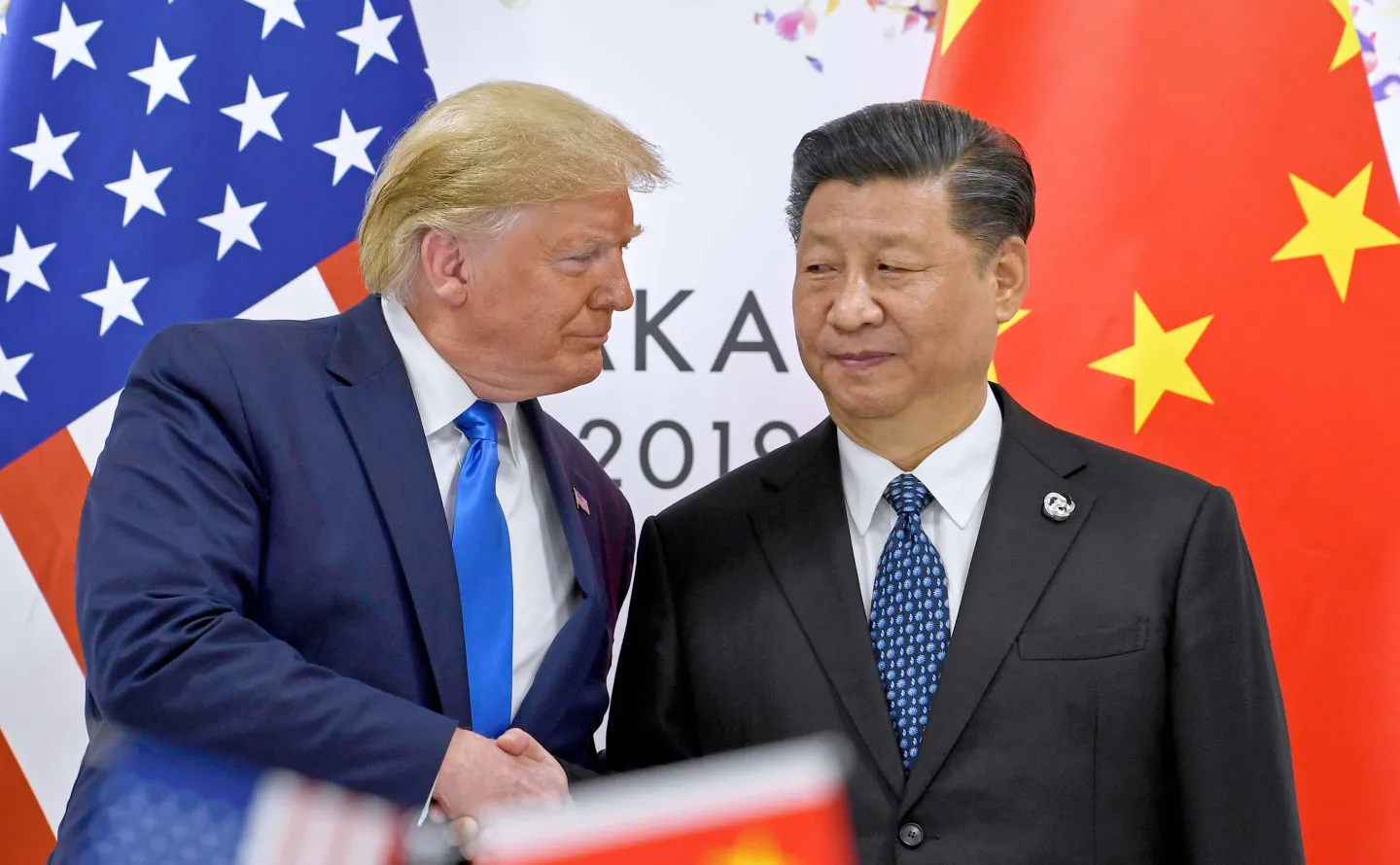 FILE - U.S. President Donald Trump, left, shakes hands with Chinese President Xi Jinping during a meeting on the sidelines of the G-20 summit in Osaka, western Japan, June 29, 2019. (AP Photo/Susan Walsh, File)