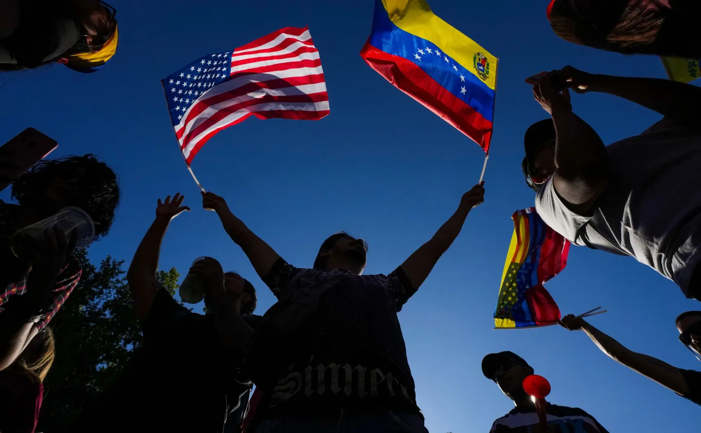 Venezuelans celebrate in Santiago, Chile, Saturday, Jan. 3, 2026, after U.S. President Donald Trump announced that President Nicolas Maduro had been captured and flown out of Venezuela. (AP Photo/Esteban Felix)