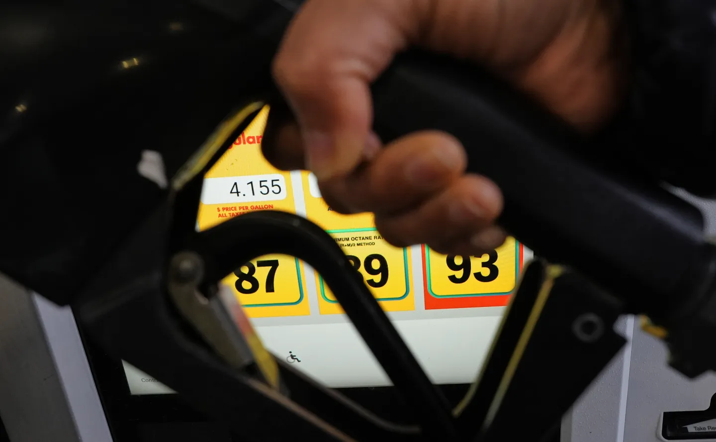 A person fills up her vehicle's gas tank at a gas station in Buffalo Grove, Ill., Thursday, April 2, 2026. (AP Photo/Nam Y. Huh)