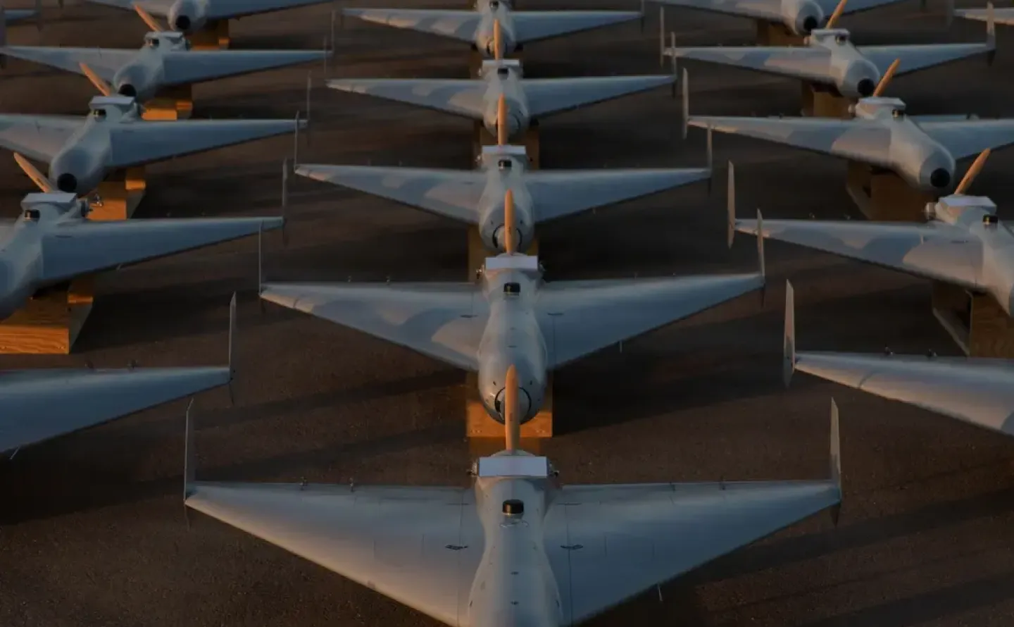 Low-cost Unmanned Combat Attack System (LUCAS) drones are positioned on the tarmac at a base in the U.S. Central Command (CENTCOM) operating area, Nov. 23. The LUCAS platforms are part of a one-way attack drone squadron CENTCOM recently deployed to the Middle East to strengthen regional security and deterrence.