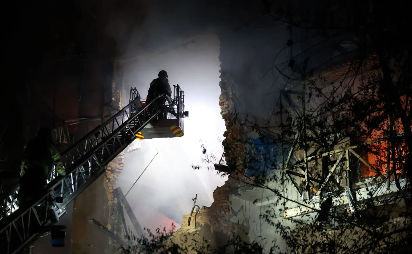 Rescue workers try to put out a fire of a residential building burning after a Russian drone attack on Zaporizhzhia, Ukraine, late Sunday, July 12, 2026. (AP Photo/Kateryna Klochko)