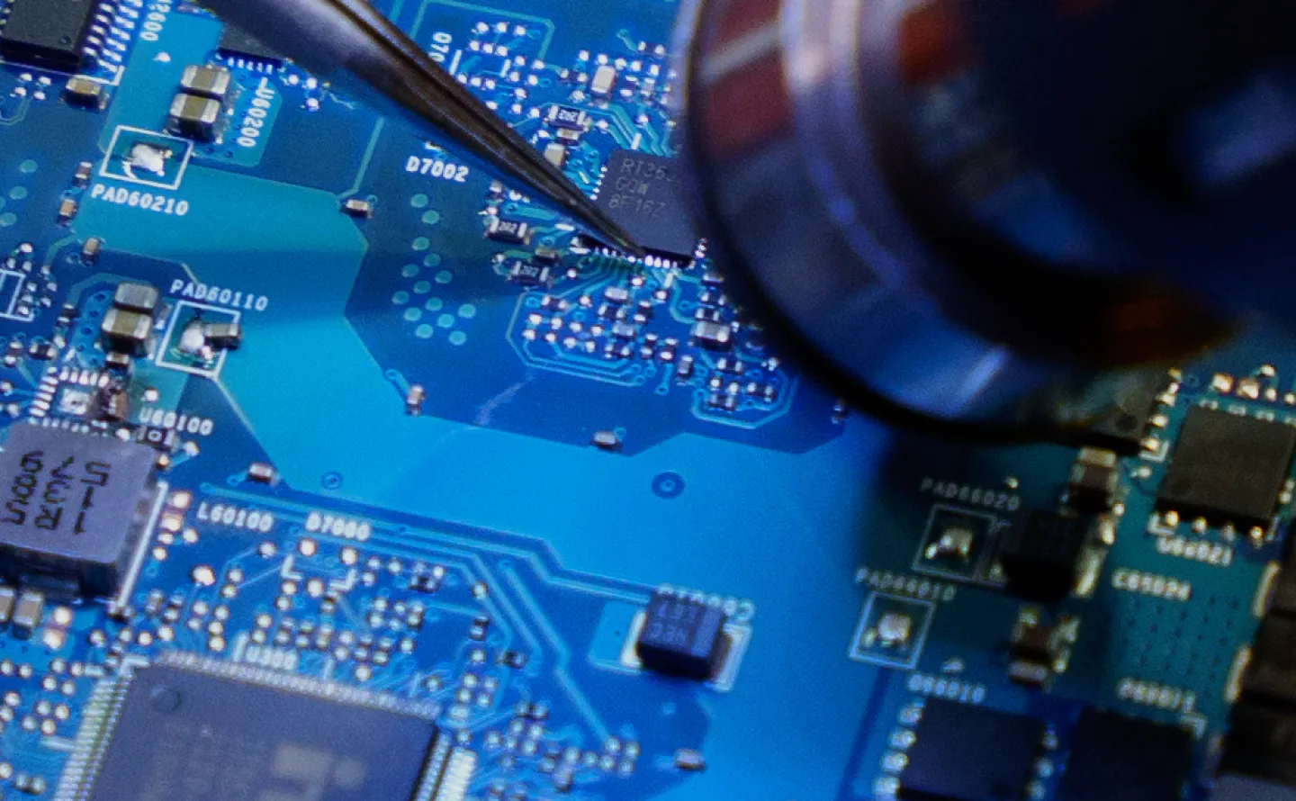 Technesia owner and repair technician Daniel Fernando solders a computer chip from a motherboard following the announcement of President Donald Trump's reciprocal tariffs on Wednesday, April 2, 2025, in Philadelphia. (AP Photo/Mingson Lau)