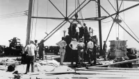 FILE - Scientists and other workers rig the world's first atomic bomb to raise it up onto a 100-foot tower at the Trinity Test Site near Alamogordo, N.M. The New Mexico site where the world’s first atomic bomb was detonated is expecting thousands of visitors Saturday due to the popularity of the movie, "Oppenheimer." Trinity Site, a designated National Historic Landmark, only opens to the public twice a year. (AP Photo/File )