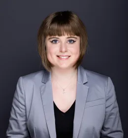 Headshot of a woman in a gray suit.