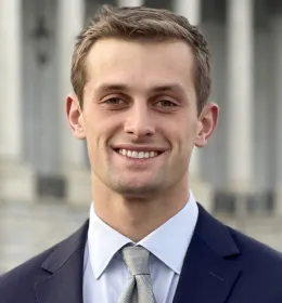 Headshot of a man in a suit.