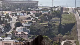 The US-Mexico border fence with Tijuana, Mexico, on the left, the Pacific Ocean in the background