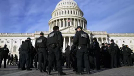 A large group of police arrive at the Capitol, Thursday, Jan. 6, 2022, in Washington. President Joe Biden and members of Congress are solemnly marking the first anniversary of the Jan. 6 U.S. Capitol insurrection. Lawmakers are holding events Thursday to reflect on the violent attack by supporters of then-President Donald Trump. The ceremonies will be widely attended by Democrats, but almost every Republican on Capitol Hill will be absent.