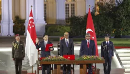 In this photo released by Singapore's Ministry of Communications and Information, Singapore's incoming Prime Minister Lawrence Wong, second from left, is sworn in next to President Tharman Shanmugaratnam, center, and Chief Justice Sundaresh Menon, second from right, at the Istana in Singapore, Wednesday, May 15, 2024. Wong was sworn in Wednesday as the nation's fourth prime minister in a carefully planned political succession designed to ensure continuity and stability in the Asian financial hub.