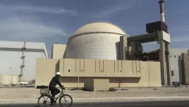 FILE - A worker rides a bicycle in front of the reactor building of the Bushehr nuclear power plant, just outside the southern city of Bushehr, Iran, Oct. 26, 2010.