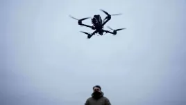 A serviceman controls an FPV drone of "General Cherry" company at the polygon in Ukraine, on Dec. 4, 2025. (AP Photo/Evgeniy Maloletka