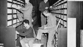 Corporal George Carter, top left, Union, West Virginia; Private Jack Easton, top right, Cokato, Minnesota; Private James Bosica, bottom left, Baltimore, Md., and Technical Sergeant William Cripps, bottom right, Houston, Texas, now with American troops in Great Britain check parts in the stores at the repair and supply depot of the United States Army Air Force Service Command in Britain, August 21, 1942. (Associated Press)