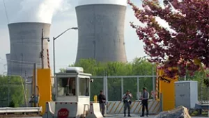 Armed personnel stand in front of the security gate leading to Three Mile Island nuclear power plant in Harrisburg, PA.