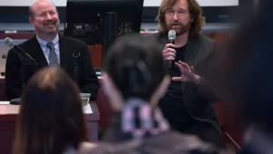 Distinguished Professor of Atmospheric Science at Penn State Michael Mann and Pulitzer Prize-winning editorial cartoonist Tom Toles introduce themselves at the Starr Auditorium at Harvard Kennedy School on Wednesday, February 14, 2018. (Benn Craig)