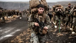 A U.S. Marine carries cold weather equipment as he begins to march across the Icelandic terrain in preparation for NATO’s Trident Juncture 2018 exercise, October 19, 2018. 