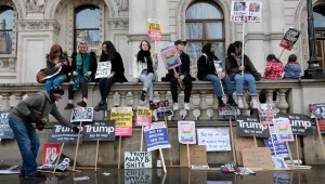Anti-Trump protesters taking a rest in Whitehall during the London march against Trump's immigration ban.