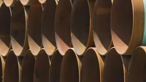 stacks of coated steel pipes