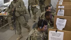 U.S. service members, including soldiers from the Army's 101st Airborne Division use computers and prepare to eat inside a tent at at a coalition air base in Qayara, some 50 kilometers south of Mosul, Iraq, Friday, Oct. 28, 2016. The U.S. military says Iraqi forces have retaken 40 villages from the Islamic State group near Mosul since a massive operation to drive the militants from the city began last week. It says Iraqi troops are consolidating gains made east and south of the city earlier this week, but i