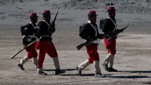 Bolivian soldiers, dressed in costumes to look like Chilean soldiers, walk during the reenactment of the battle of "Canchas Blancas," which took place in 1879 during the Pacific War that Bolivia lost to Chile. Wednesday, March 28, 2018.