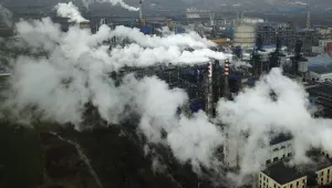 In this Nov. 28, 2019 file photo, smoke and steam rise from a coal processing plant in Hejin in central China's Shanxi Province.