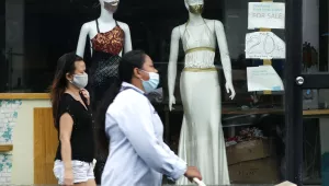 Women walk past mannequins wearing face masks advertised for sale, at a shop in Makati city, Philippines, Tuesday, Sept. 29, 2020.