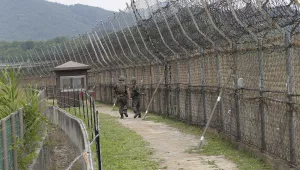 In this June 14, 2019, file photo, South Korean army soldiers patrol while hikers visit the DMZ Peace Trail in the demilitarized zone in Goseong, South Korea. 