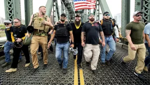 Photo of members of the Proud Boys, including organizer Joe Biggs, third from right, march across the Hawthorne Bridge during an "End Domestic Terrorism" rally in Portland, Ore., on Saturday, Aug. 17, 2019. Biggs was arrested Wednesday, Jan. 20, 2021 for taking part in the siege of the U.S. Capitol. 