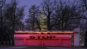 An illuminated traffic barrier is seen on the Capitol grounds before sunrise in Washington, Monday, March 8, 2021.