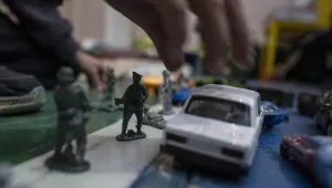 A boy plays with his toy soldiers inside a school that is being used as a shelter for people who fled the war, in Dnipro city, Ukraine, on Tuesday, April 12, 2022.