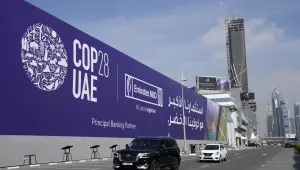 Cars pass by a billboard advertising COP28 at Sheikh Zayed highway in Dubai, United Arab Emirates, Monday, Nov. 27, 2023. Representatives will gather at Expo City in Dubai, UAE, Nov. 30 to Dec. 12 for the 28th U.N. Climate Change Conference, known as COP28.