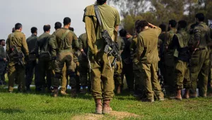 Israeli soldiers gather as they are briefed after coming back from the Gaza Strip at a staging area in southern Israel, Sunday, Dec. 17, 2023.