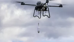 This photo released by the Russian Defense Ministry Press Service Saturday, April 20, 2024, shows an unmanned aerial vehicle drop a dummy bomb during its flight as Russian Defense Minister Sergei Shoigu visits the training ground of the Moscow Military District.