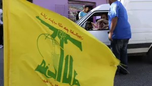 Hezbollah supporters distribute sweets to passersby, as they celebrate the fall of the Syrian town of Qusair to forces loyal to President Bashar Assad and Hezbollah fighters, in Bazzalieh village, Lebanon, near the Lebanese-Syrian border, Wednesday, June 5, 2013.