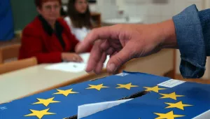 A Slovenian casts his ballot in a box bearing a European Union crest at a polling station in Grosuplje near Ljubljana, Sunday, Oct. 3, 2004. Nationwide general elections are taking place in Slovenia on Sunday. Slovenia joined the EU and NATO earlier this year.