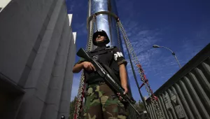 A soldier guards a transport cask containing a transfer cylinder that holds highly enriched uranium at "La Reina" reactor in Santiago, Chile on February 18, 2010. (AP Photo/Jorge Saenz)