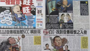 In this image made on Friday, April 27, 2012, pages of rival Taiwan newspapers Apple Daily, top half, and The China Times, bottom, are seen depicting each other’s owners in a fight for ownership of a major chunk of Taiwan’s media outlets. (AP)