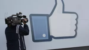 A television photographer shoots the Like sign outside of Facebook headquarters in Menlo Park, California on Friday, May 18, 2012. (AP Photo/Paul Sakuma)