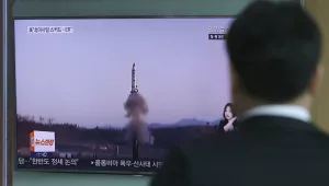 A man watches a TV news program reporting about North Korea's missile firing in Seoul, South Korea, on Thursday, April 6, 2017. (AP Photo/Lee Jin-man)