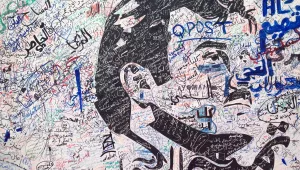A black-and-white depiction of Qatar's emir, Sheikh Tamim bin Hamad Al Thani, attracts signatures and comments of support from residents amid a diplomatic crisis between Qatar and neighboring Arab countries in Doha, Qatar, on July 3, 2017 (AP Photo/Maggie Hyde).